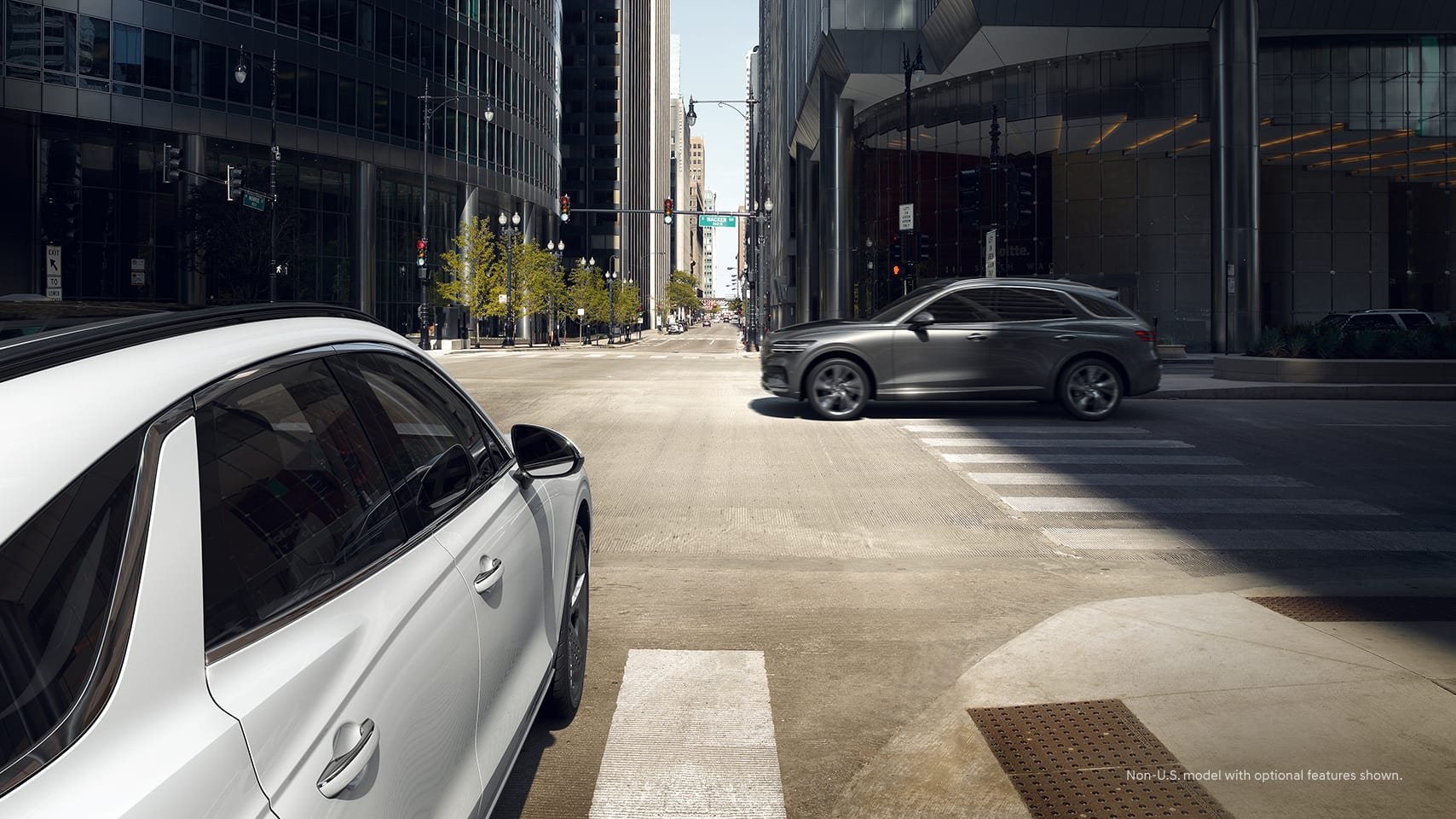 2023 Genesis GV70 at an intersection with another vehicle.