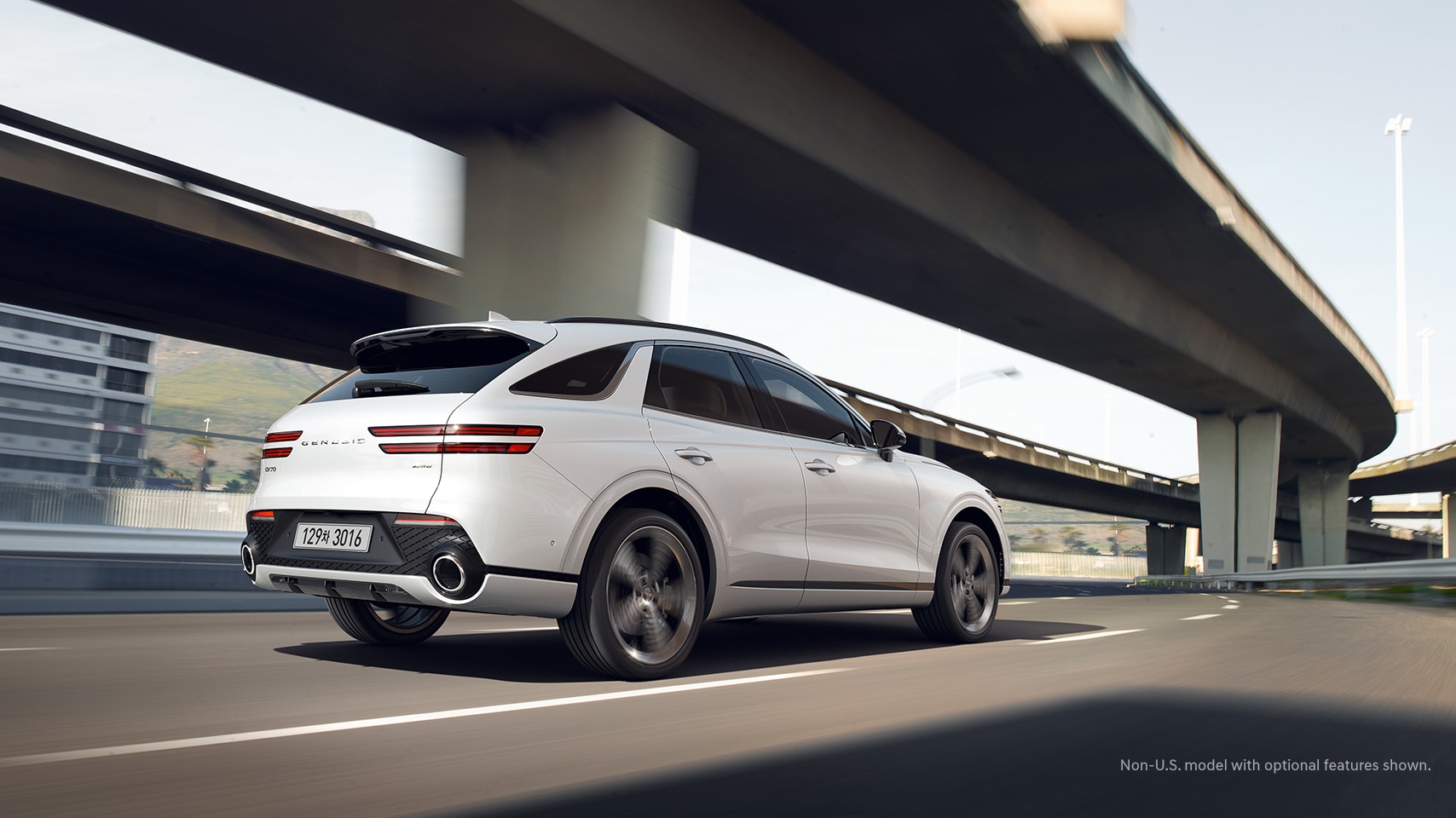 2023 Genesis GV70 shown in Alta White on highway.
