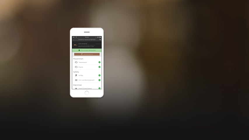 An iPhone showing a Genesis Monthly Vehicle Report.