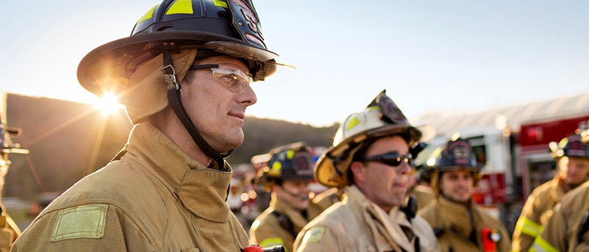 Team of firefighters in front of a fire truck