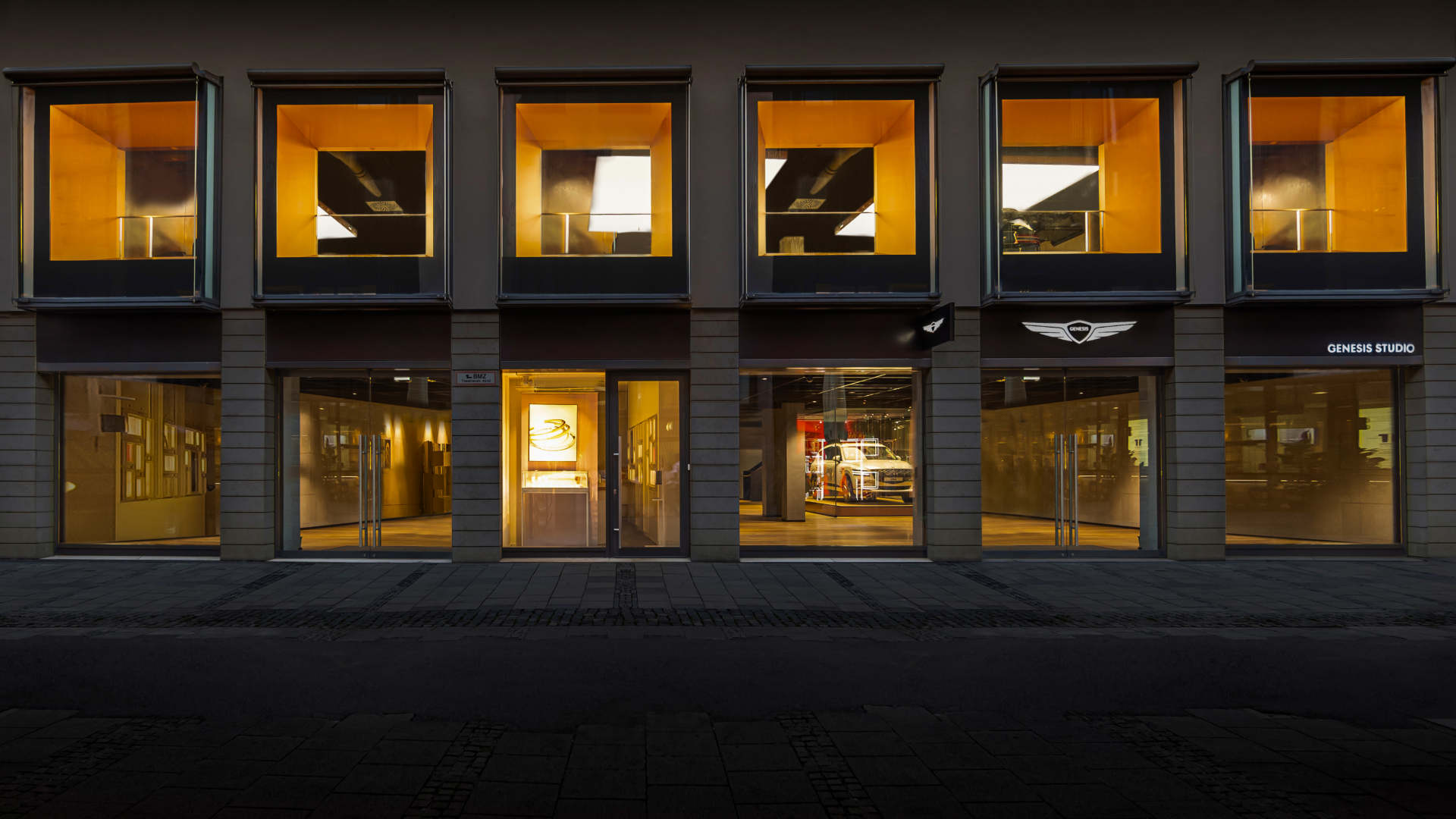 An exterior view of Genesis Studio Frankfurt and its interior.