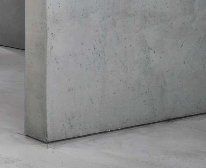 A gray exposed concrete wall.
