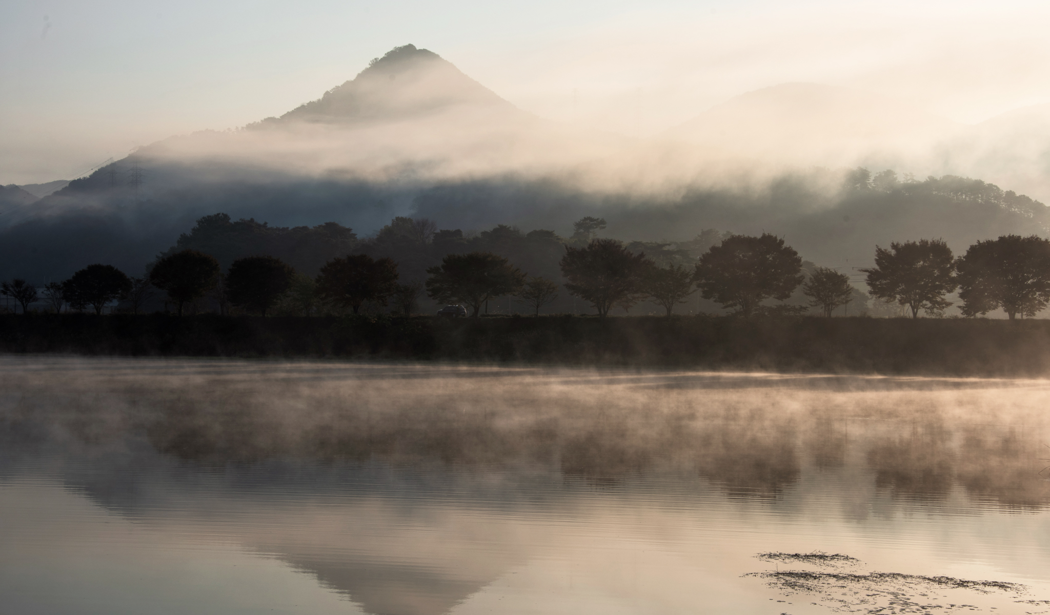 Fog gives a river and mountain scene a mystical feeling.